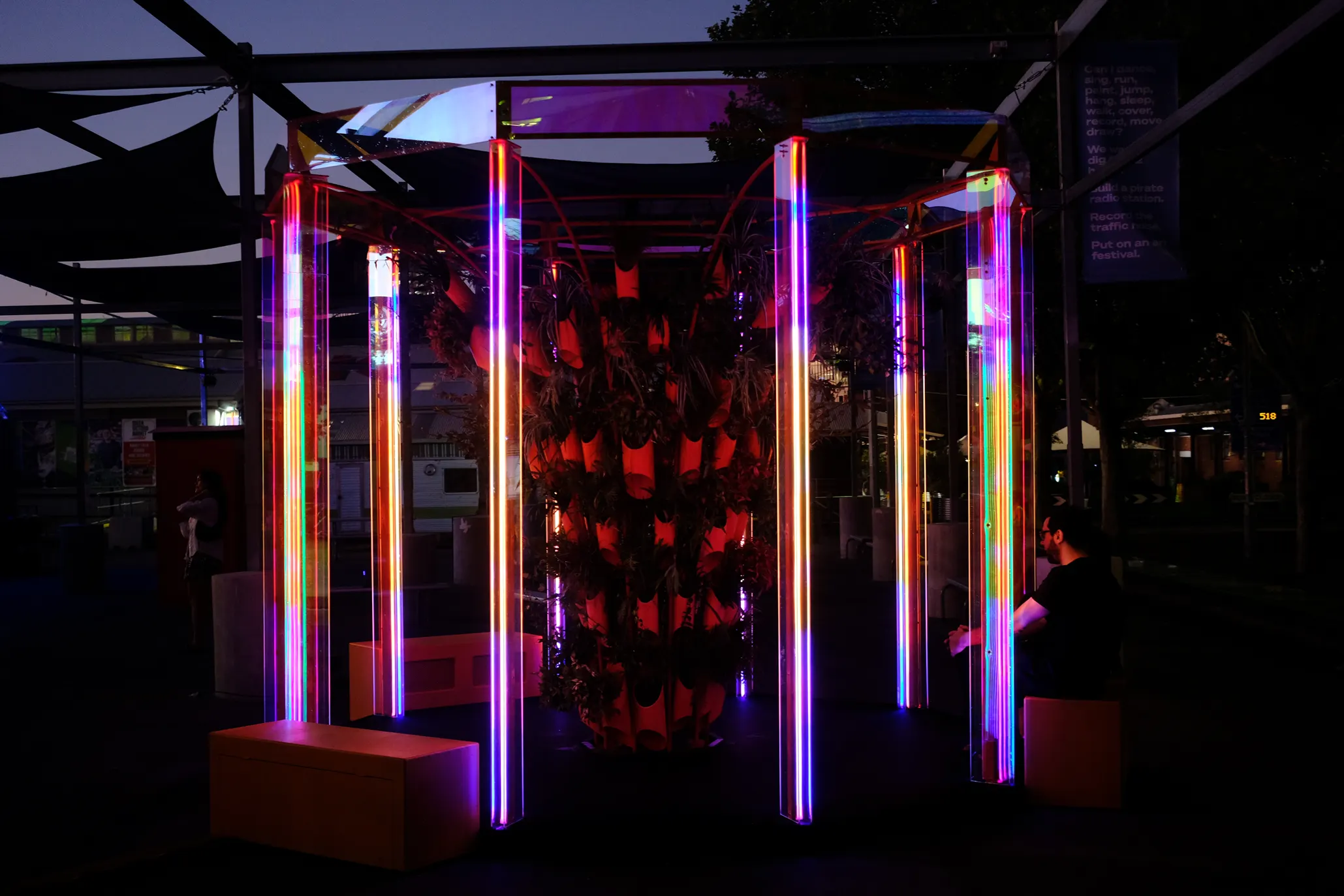 Glowing columns seen across the plaza