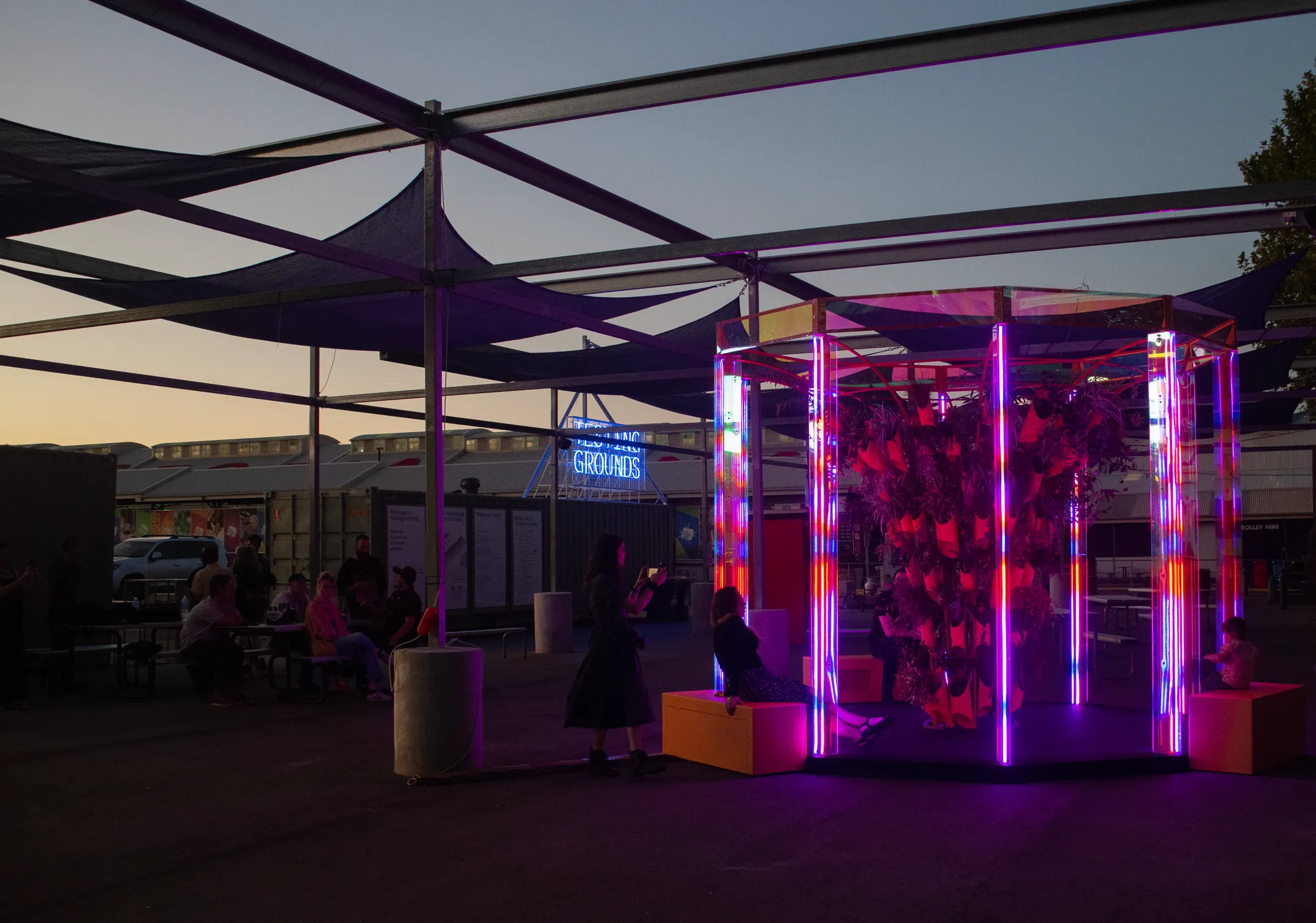 The installation at dusk under shade sails